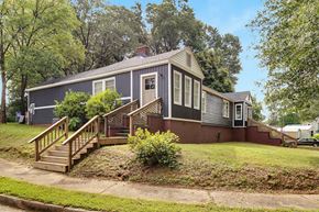 Spartanburg house for rent - A house with a grey roof and a red brick wall.