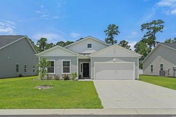 Myrtle Beach house for rent - A house with a garage is surrounded by other similar houses.