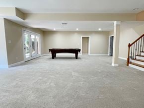 Louisville house for rent - A spacious living room with a bench and a staircase.