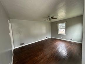Provo house for rent - A room with a ceiling fan and a window.