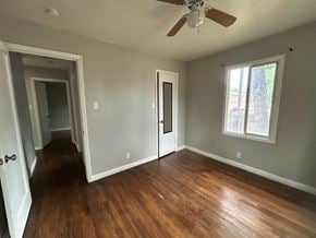 Provo house for rent - A room with a ceiling fan and hardwood floors.
