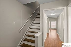 Hattiesburg house for rent - A staircase with wooden steps and a white railing.
