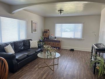 Payson house for rent - A living room with a black couch and a coffee table.