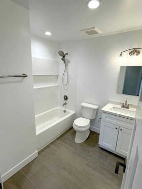 San Diego apartment for rent - A white bathroom with a toilet, sink, and shower.