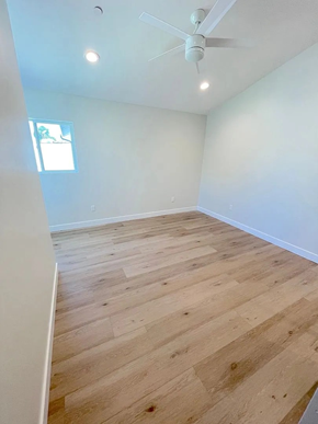 San Diego apartment for rent - A room with wooden flooring and a ceiling fan.