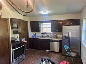 Oklahoma City house for rent - A kitchen with a stove, sink, and refrigerator.