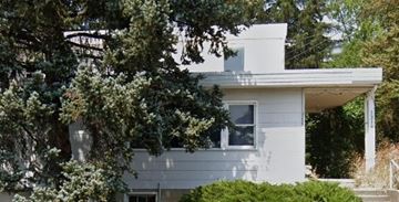 Pullman apartment for rent - A white house with a tree in front.