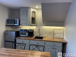 Colorado Springs apartment for rent - A kitchen with a wooden counter top and a fridge.