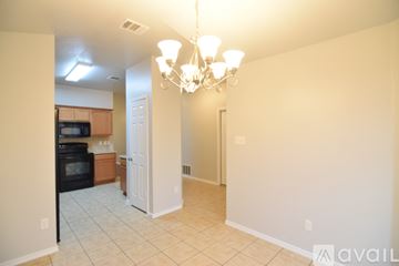Killeen house for rent - A kitchen with wooden cabinets and a black refrigerator.