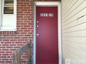 Baltimore apartment for rent - A red door with the number 3033 on it.