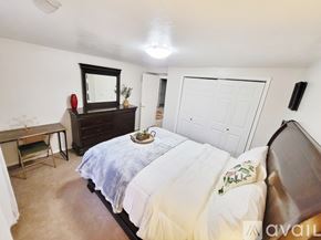 Idaho Falls apartment for rent - A bedroom with a bed, dresser, and mirror.