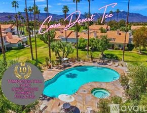 Palm Desert house for rent - A pool surrounded by palm trees and a sign that says Casa Desert Tee.