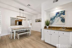 Palm Desert house for rent - A modern kitchen with a dining table and chairs.