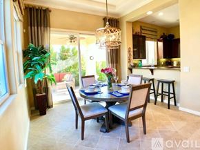 La Quinta house for rent - A dining room with a table set for two and a bar area in the background.