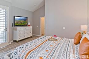 La Quinta house for rent - A bedroom with a large bed and a television on a cabinet.