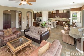 La Quinta house for rent - A living room with a brown couch and a glass coffee table.