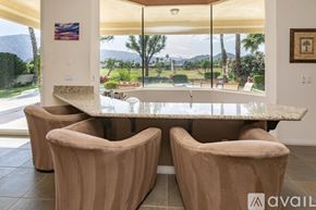 La Quinta house for rent - A dining room with a table and chairs and a mountain view.