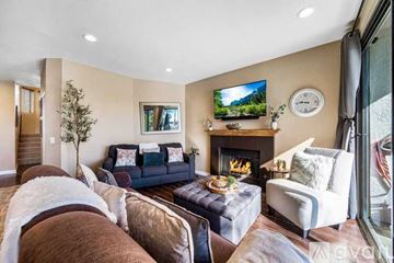 La Quinta house for rent - A living room with a fireplace and a television on the wall.