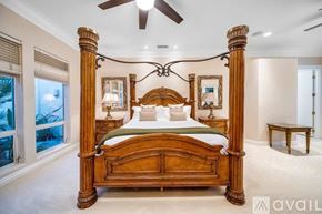 La Quinta house for rent - A bedroom with a large bed and a ceiling fan.