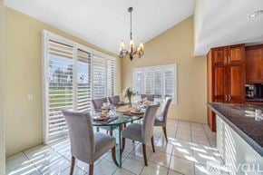 La Quinta house for rent - A dining room with a glass table and chairs.
