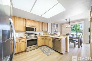 La Quinta house for rent - A kitchen with wooden cabinets and stainless steel appliances.
