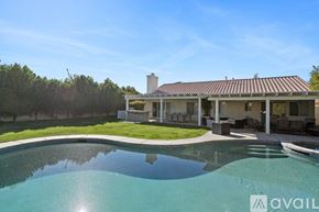 La Quinta house for rent - A house with a pool in front of it.