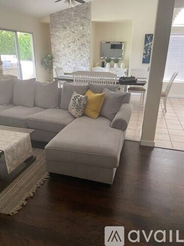 La Quinta house for rent - A living room with a grey couch and a white radiator.