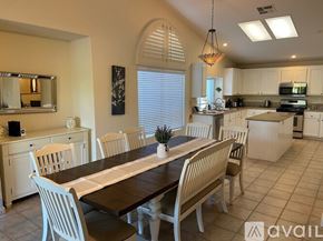 La Quinta house for rent - A dining room with a long table and chairs.
