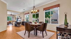 La Quinta house for rent - A dining room with a table set for four and a chandelier hanging from the ceiling.