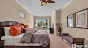 La Quinta house for rent - A bedroom with a large bed and a ceiling fan.