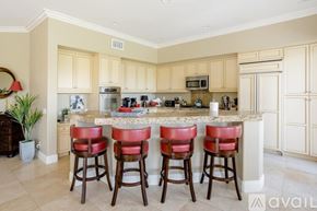 La Quinta house for rent - A kitchen with a bar area featuring a counter and four stools.