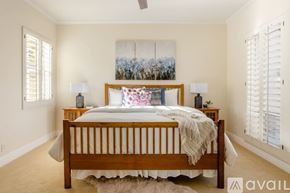 La Quinta house for rent - A bedroom with a large bed and a painting on the wall.