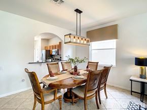 Kissimmee house for rent - A dining room with a table set for four.