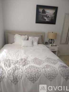 San Leandro house for rent - A bed with a white comforter and pillows is in the image.