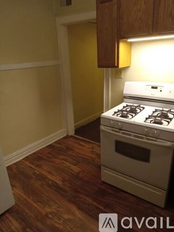 East Chicago apartment for rent - A white stove in a kitchen with wooden floors.
