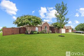Harker Heights house for rent - A house with a brown fence and a tree in front.