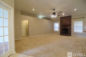Harker Heights house for rent - A spacious living room with a fireplace and a ceiling fan.
