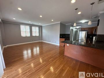 Chicago apartment for rent - A kitchen with wooden floors and stainless steel appliances.