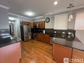 Chicago apartment for rent - A kitchen with wooden floors and a refrigerator.