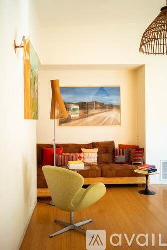 Los Angeles County house for rent - A living room with a yellow chair and a painting on the wall.