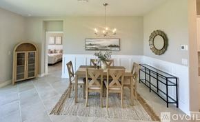 Port Charlotte house for rent - A dining room with a table set for six.