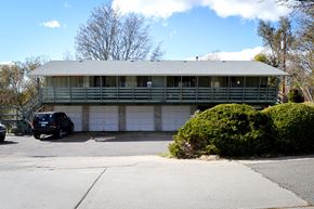 Lakewood apartment for rent - A green house with a car parked in front.