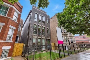 Chicago apartment for rent - A row of houses with a black fence in front.