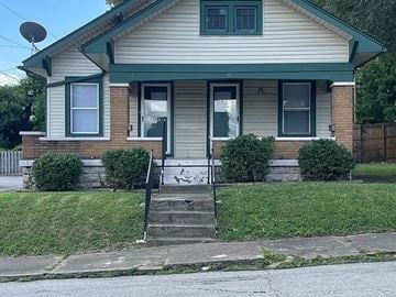 New Albany house for rent - A house with a green door and windows.