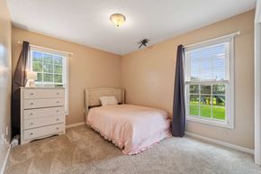 Jacksonville house for rent - A bedroom with a bed, dresser, and window.