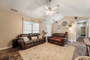 Jacksonville house for rent - A living room with two brown leather couches and a rug.