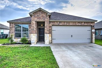 Temple house for rent - A house with a brick facade and a white garage door.