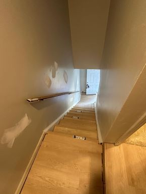 Atlanta house for rent - A staircase with a wooden floor and a wall on the side.