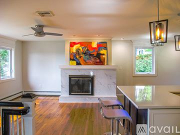 Brookfield house for rent - A living room with a fireplace and a painting on the wall.