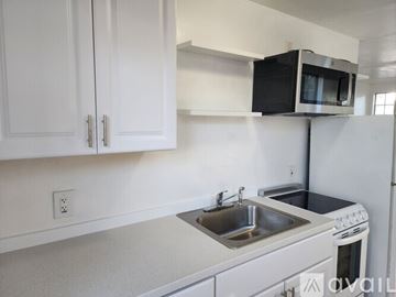 San Diego house for rent - A kitchen with white cabinets and a white oven.